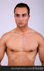 young sensual man on a grey background
