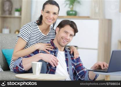young serious couple holding reading financial documents