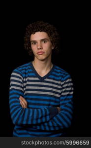 young serious man portrait, on a black background