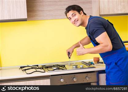 Young service contractor assembling kitchen furniture