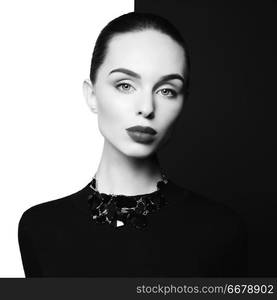 young sexy lady with black stylish bijouterie in black-and-white studio. beautiful woman with perfect lips and black lipstick pose in photostudio. Fashion portrait of fashionable model.