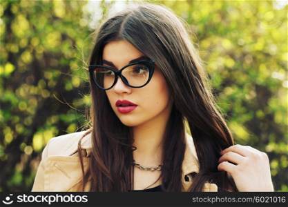 Young sexy woman closeup portrait. Stylish hipster girl posing on the street with interested look. Vintage lifestyle trendy portrait.