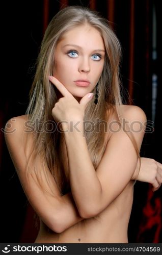 Young sexy woman in dark studio