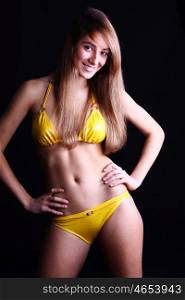Young sexy woman in yellow bikini