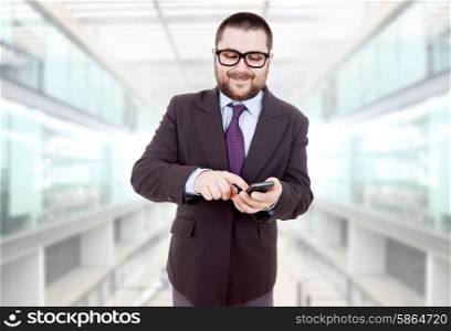 young silly business man using his phone at the office