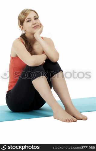 young sitting cute fitness woman. young sitting cute blonde fitness woman on white background
