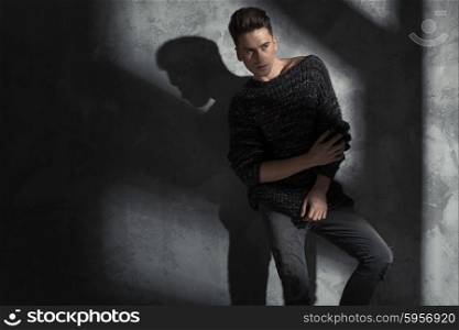 Young slim man wearing trendy woolen sweater