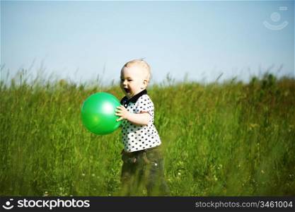 young smile boy play green ball