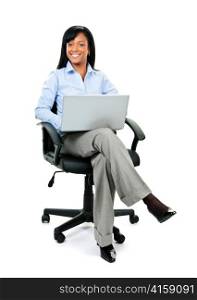 Young smiling black business woman sitting in leather office chair with laptop computer