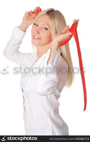 Young smiling blonde in a white shirt plays with a red ribbon in the hands