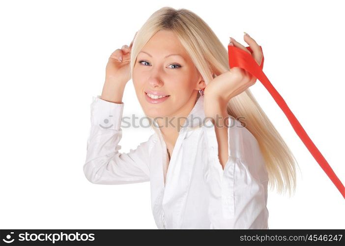 Young smiling blonde in a white shirt plays with a red ribbon in the hands