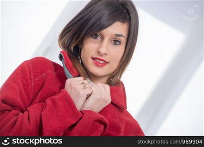 young smiling brunette woman with a red jacket