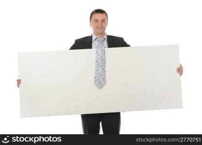 Young smiling businessman in black suit holding large blank. Isolated on white background