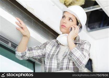 young smiling businesswoman builder on the phone