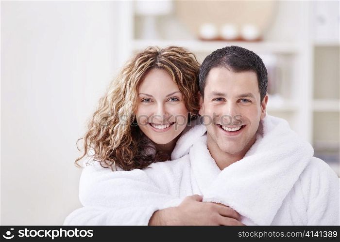 Young smiling couple in dressing gowns at home