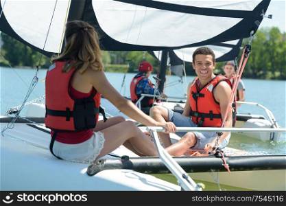 young smiling couple on a sailing boat