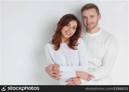 Young smiling couple. Portrait of young smiling couple in white