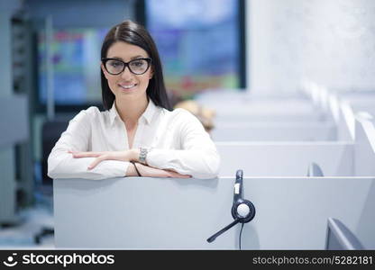 young smiling female call centre operator doing her job with a headset