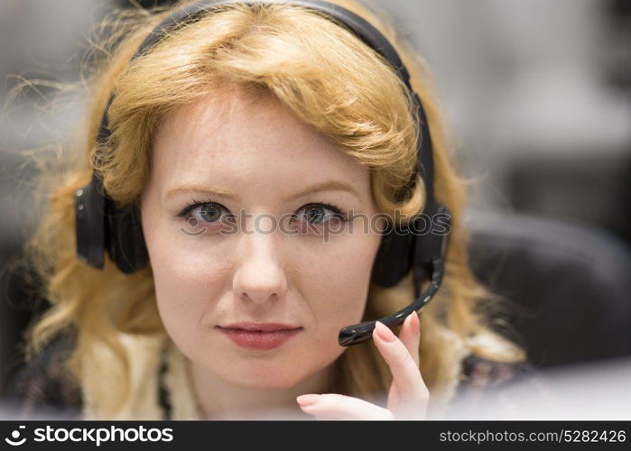 young smiling female call centre operator doing her job with a headset