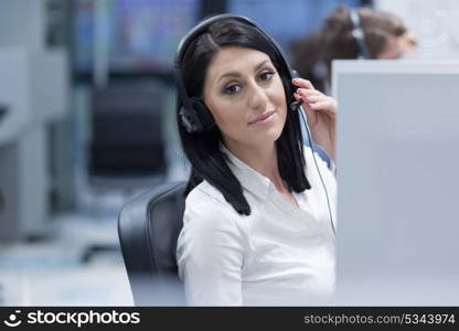 young smiling female call centre operator doing her job with a headset