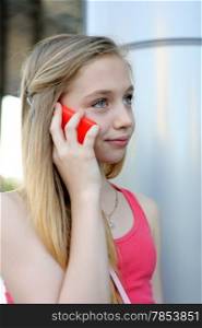 Young smiling girl having a phone talk outdoor