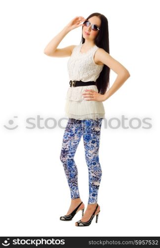 Young smiling girl in blue pants with sunglasses isolated