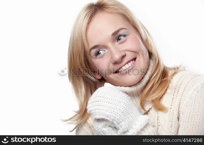 Young smiling girl in the mittens on a white background