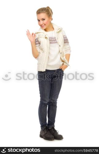 Young smiling girl shows ok gesture isolated