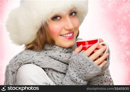 Young smiling girl with mug on winter background