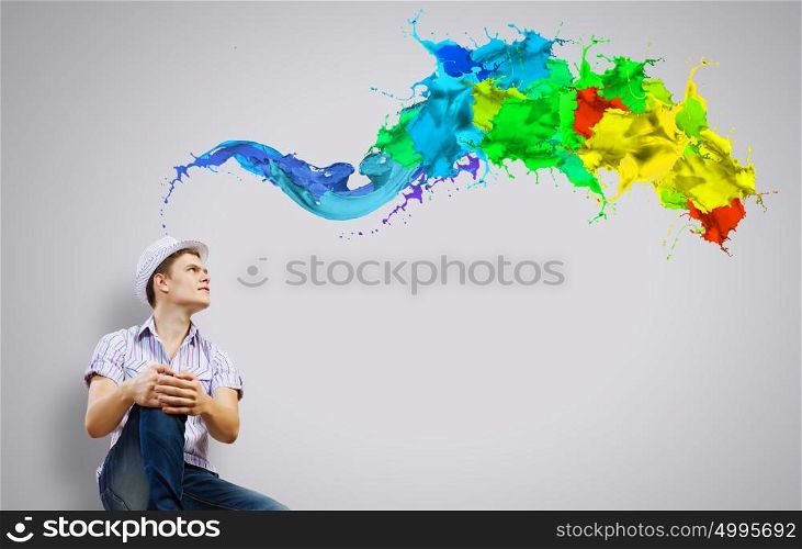 Young smiling man. Young man in casual sitting and thinking. Creativity concept