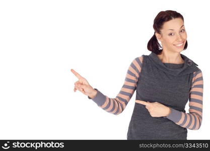 Young smiling woman in casual clothing showing something on the left, isolated on white background.