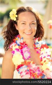 Young smiling woman in hawaiian flowers garland on the beach. Summer vacations concept
