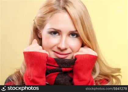 Young smiling woman in red sweater