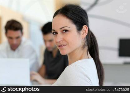 Young smiling woman in work meeting