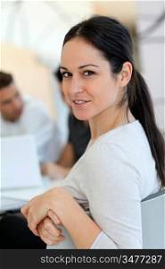 Young smiling woman in work meeting