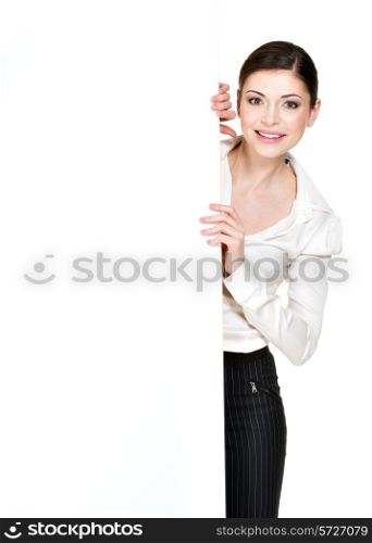 Young smiling woman looking from white blank banner - on white background