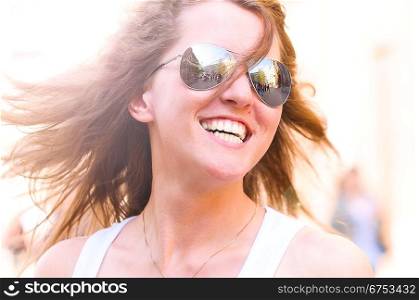 young smiling woman on bright city street