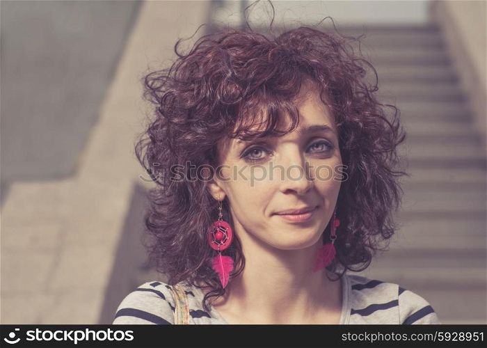 Young smiling woman outdoors portrait. Soft sunny colors.Close-up portrait. Toned image