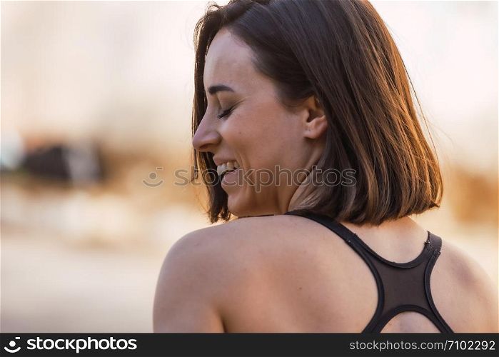 Young smiling woman profile with her eyes closed