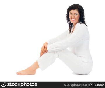 Young smiling woman sitting on floor isolated