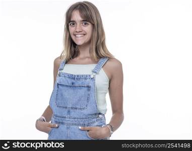 Young smiling woman standing with hands in pockets, wearing Texan jumpsuit with copy space, isolated on white background