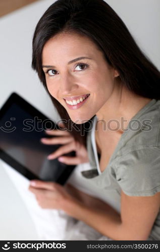 Young smiling woman using electronic tablet