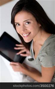 Young smiling woman using electronic tablet
