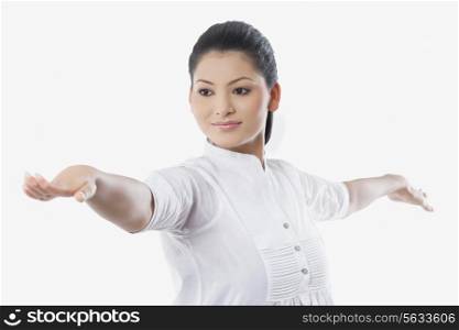 Young smiling woman with arms outstretched looking away