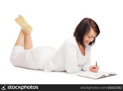 Young smiling woman with book and pen isolated
