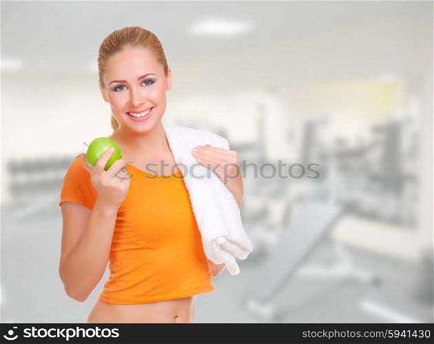 Young smiling woman with green apple and towel