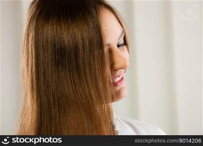 Young smiling woman with long straight healthy and smooth hair. Gorgeous Hair.