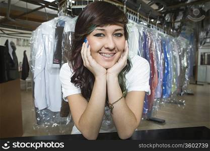 Young smiling woman working in laundrette