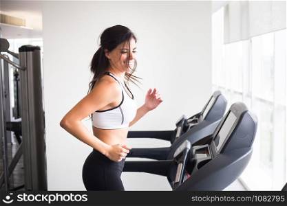 Young smiling woman workout in gym treadmill healthy lifestyle