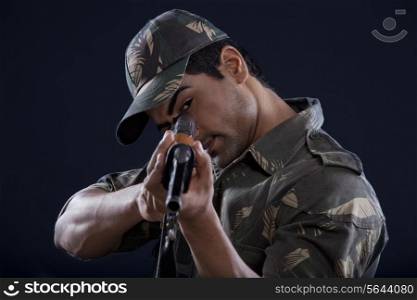 Young soldier aiming gun
